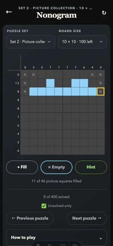 An in-progress 10 by 10 Nonogram board with the top of a heart partly filled and known empty squares crossed out